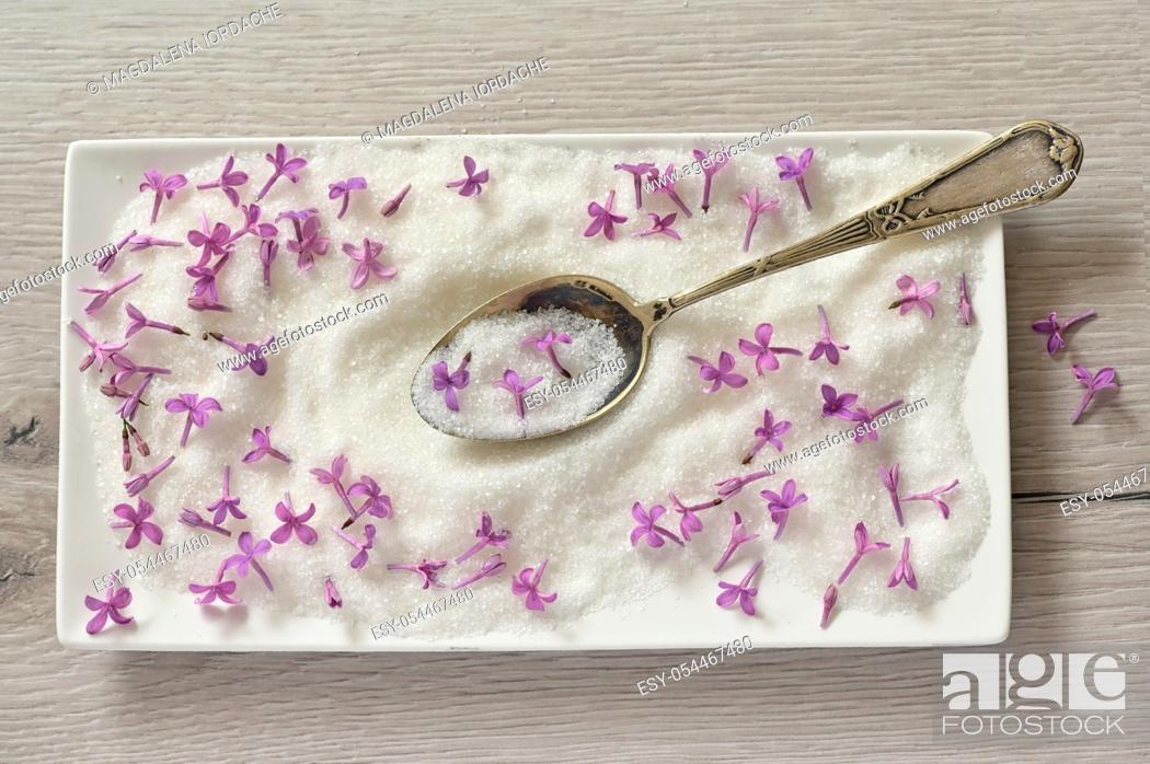 Stock Photo: Lilac Sugar In Spoon And Plate On WoodenTable.