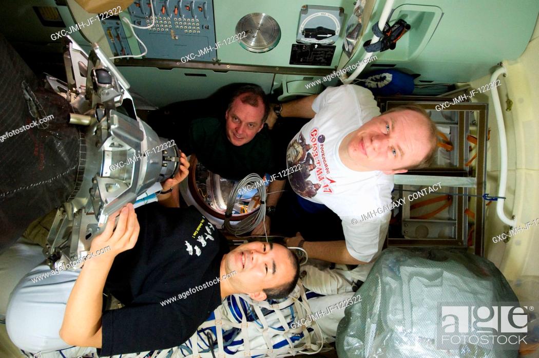 Stock Photo: Russian cosmonaut Oleg Kotov (right), Expedition 23 commander; Japan Aerospace Exploration Agency (JAXA) astronaut Soichi Noguchi (bottom) and NASA astronaut T.