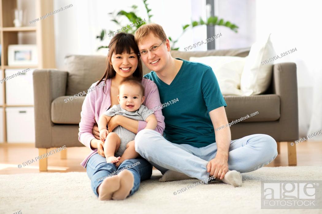 Stock Photo: happy family with baby boy at home.