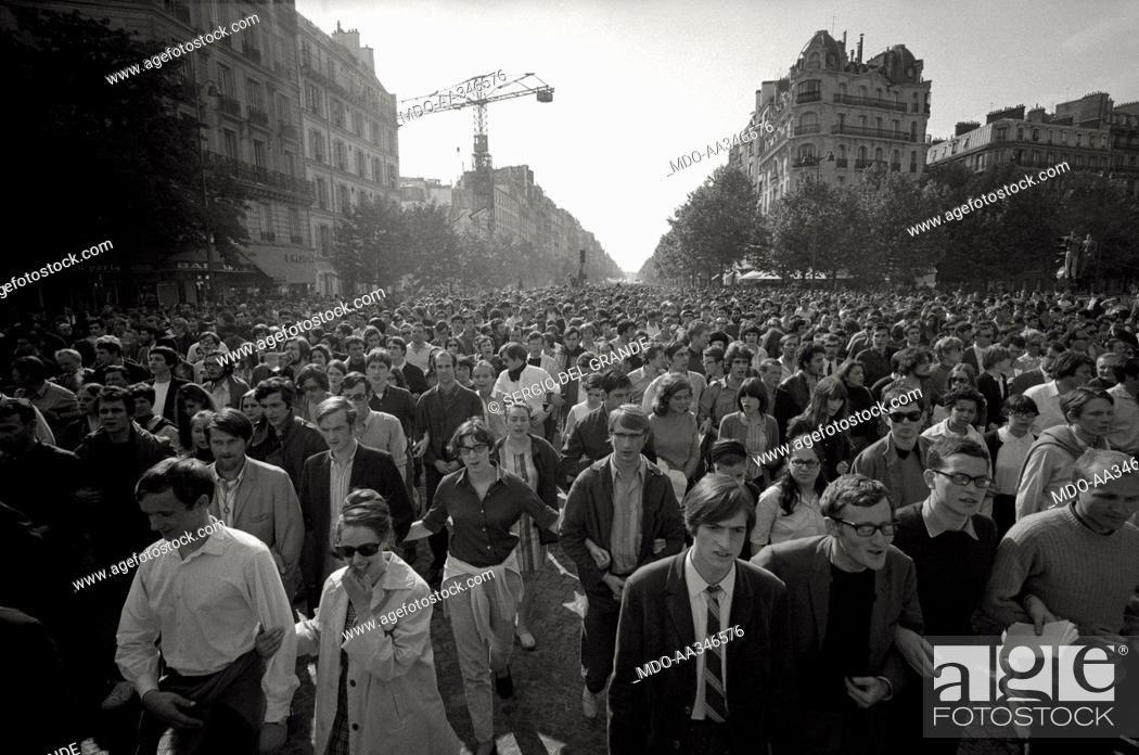 Stock Photo: The risk of a revolution in Paris has been averted. View of the crowd of a huge demonstration of young people on a boulevard of Paris.