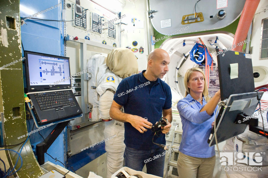 Stock Photo: NASA astronaut Karen Nyberg and European Space Agency astronaut Luca Parmitano, both Expedition 3637 flight engineers, participate in a space station EVA.