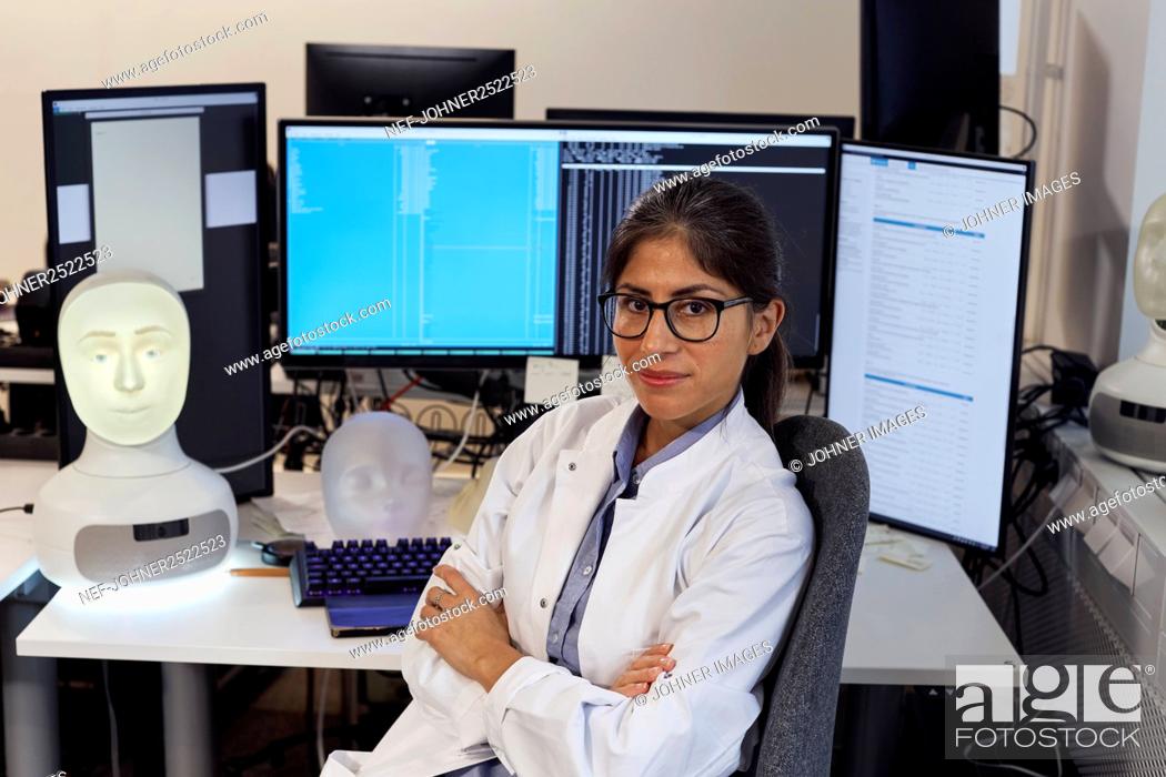 Stock Photo: Portrait of female engineer at work station.