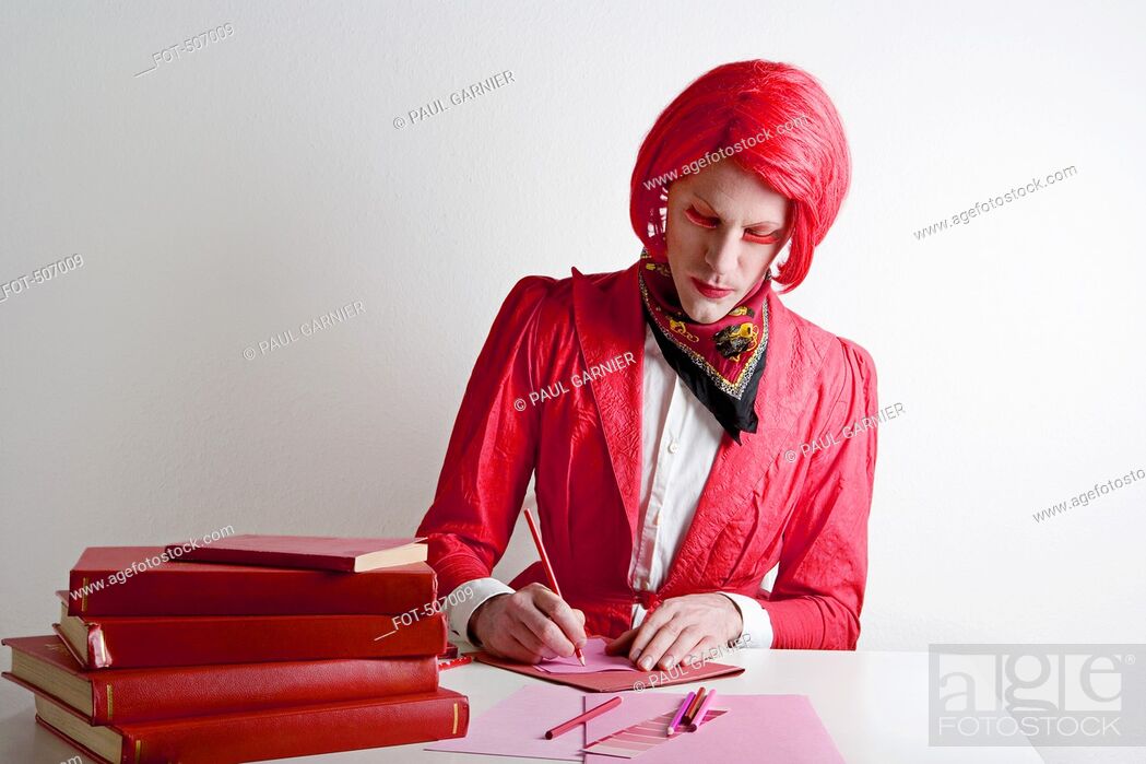 Stock Photo: Drag queen sitting at desk.