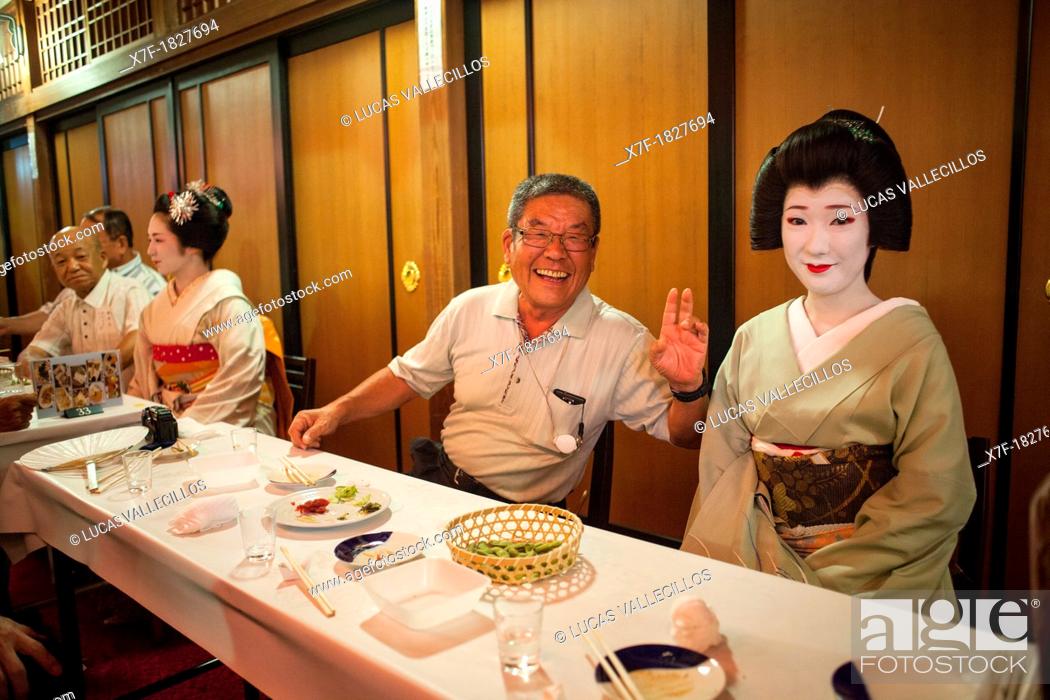 Stock Photo: Geishas and clients in Ochaya tea house Geisha's distric of Kamishichiken Kyoto  Kansai, Japan.