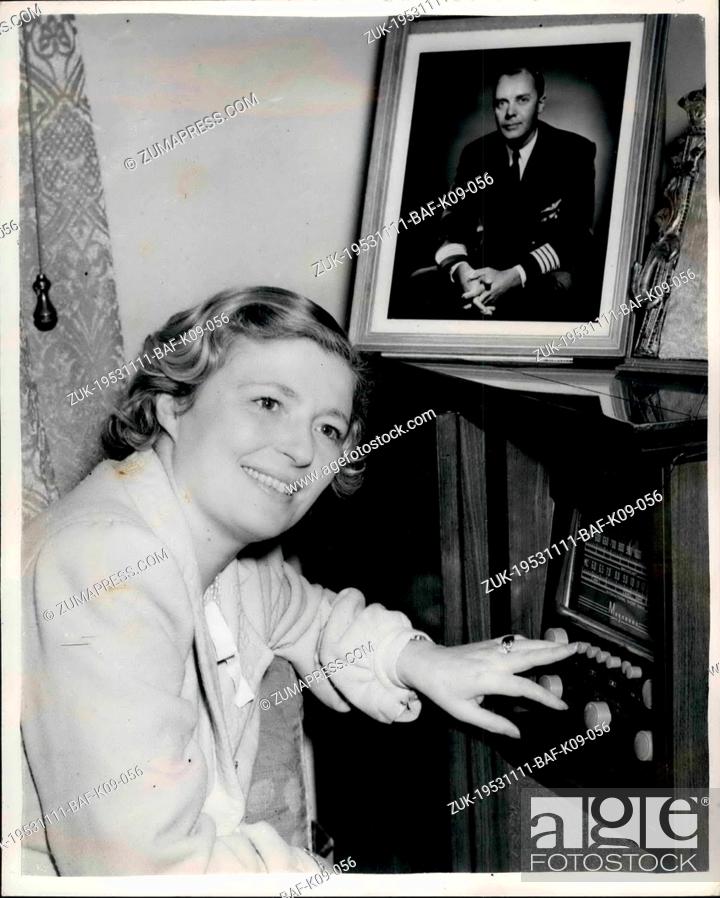 Stock Photo: Nov. 11, 1953 - Royal Pilot's Home Raided - Twice. Mrs. Loraine Listews to the radio.: Mrs. Mary Loraine, wife of Captain A.C.