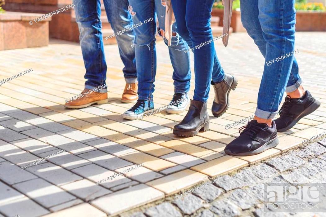 Photo de stock: Feeling like at home on campus. Cropped shot of university students feet walking outdoor.