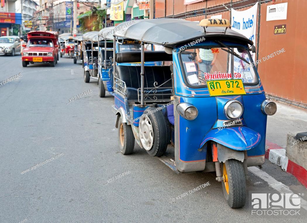 Stock Photo: City Street with Tuk Tuks or traditional taxis, near Thanon Changklan, Chiang Mai, Thailand.