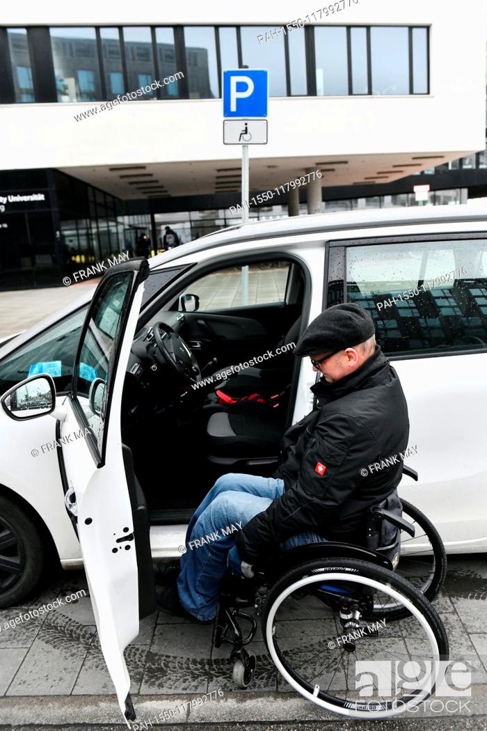 Stock Photo: A wheelchair user getting out of his car, Germany, city of Hamburg, 05. March 2019. Photo: Frank May (model released) | usage worldwide.