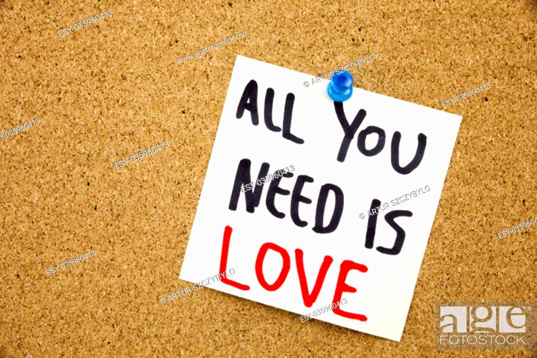 Stock Photo: Phrase ALL YOU NEED IS LOVE in black ext on a sticky note pinned to a cork notice board.