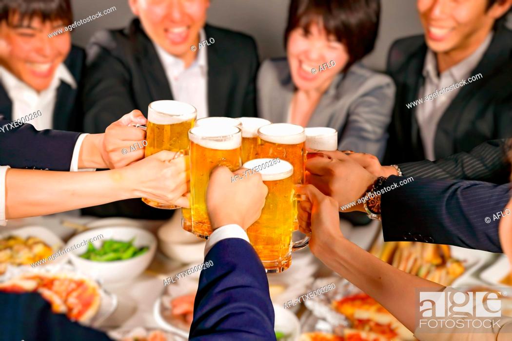 Stock Photo: Group of young Japanese friends toasting with beer.