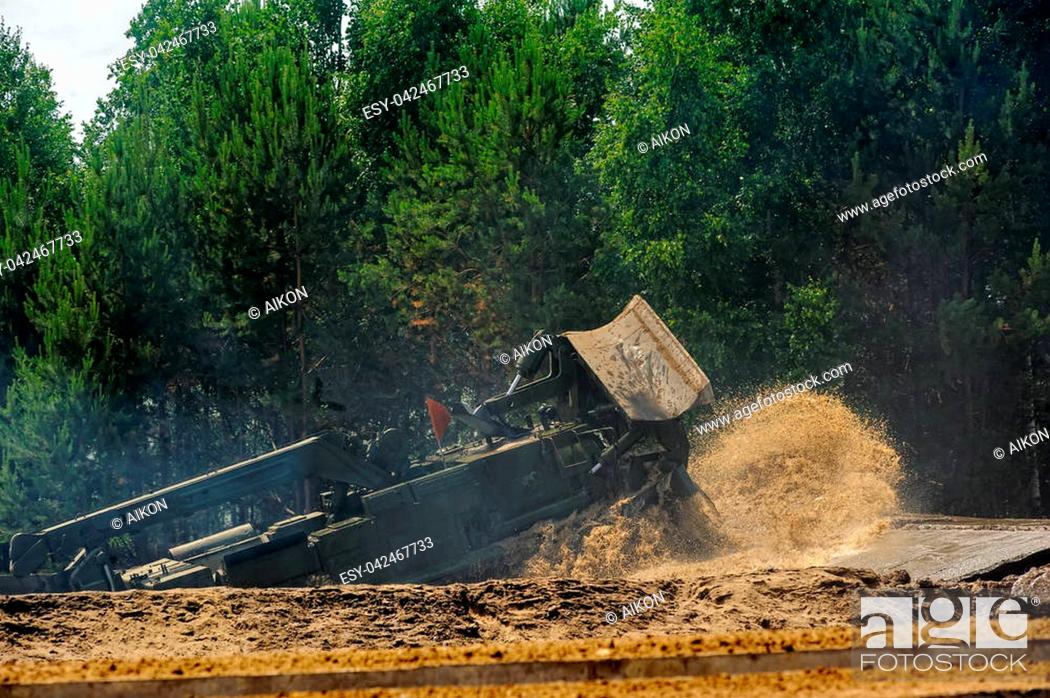 Stock Photo: Tyumen, Russia - June 23, 2017: Army Games. Engineering Formula contest. Highest military and engineering school ground. Speed driving of BAT track layer and.