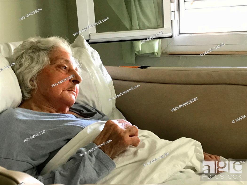 Stock Photo: Old woman in bed in a nursing home.