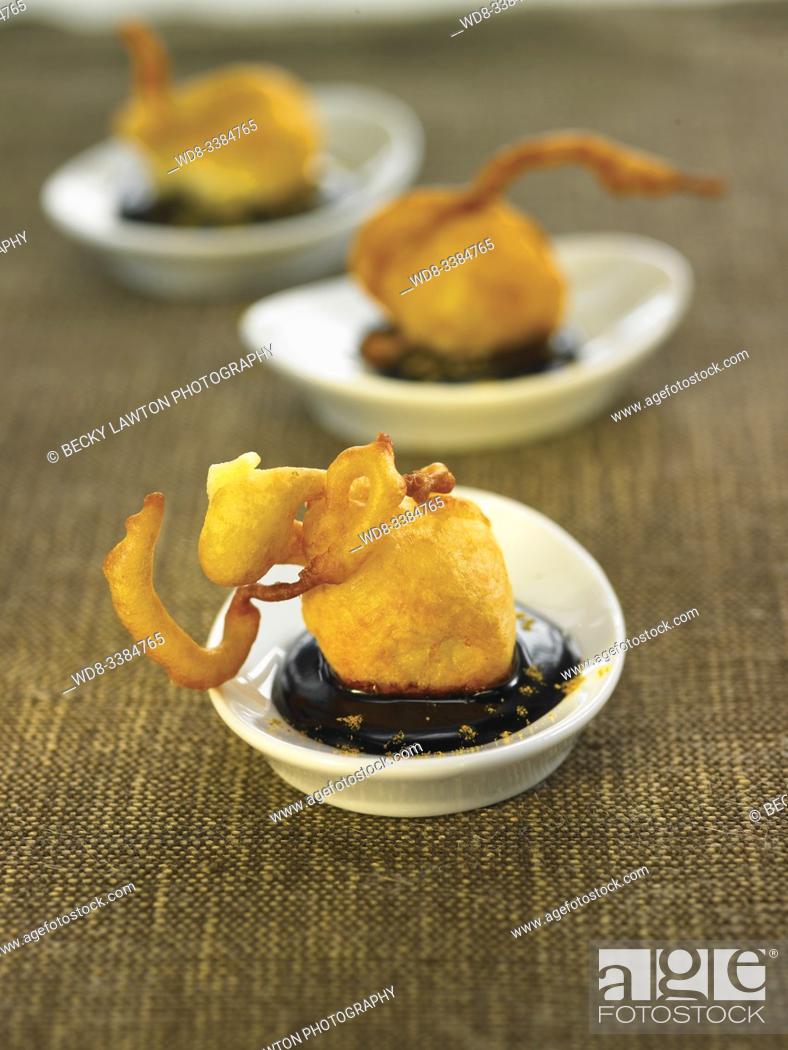 Stock Photo: bunuelos de manzana con coulis de chocolate al curry / Apple muffins with curry chocolate coulis.