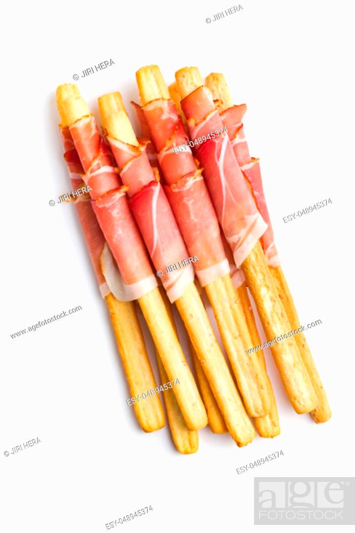Imagen: Parma ham prosciutto with grissini breadsticks isolated on white background.