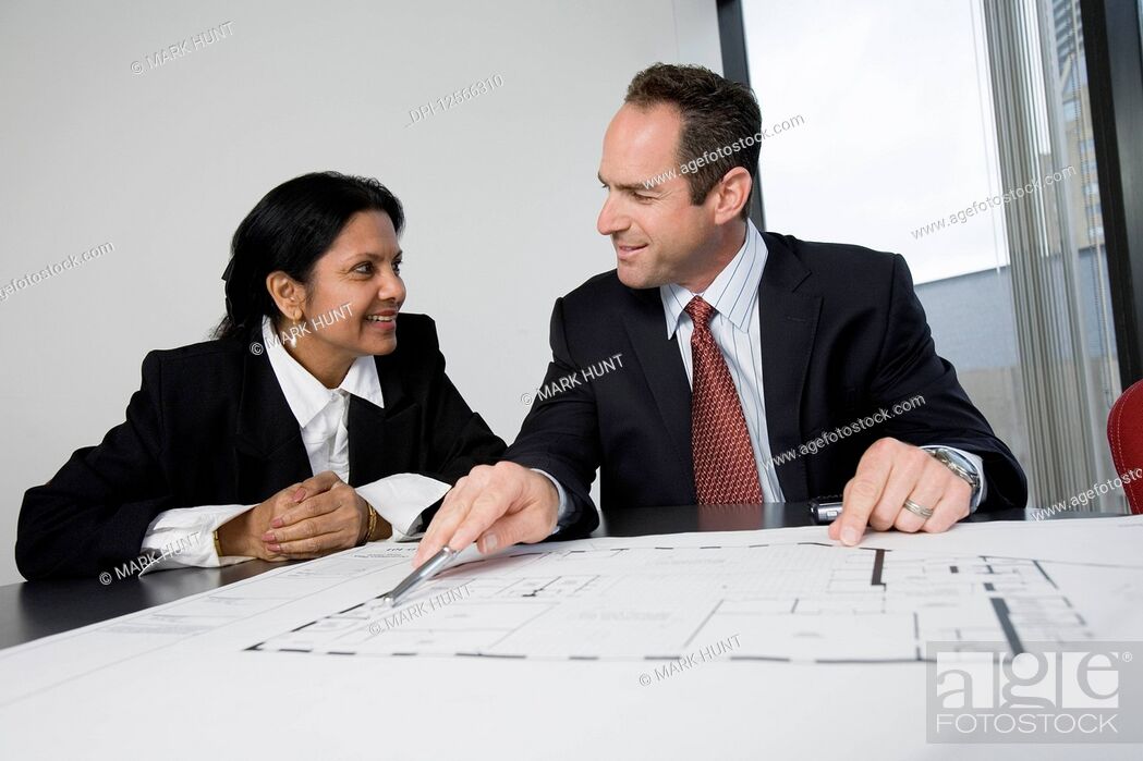 Stock Photo: View of an architect smiling with a businesswoman.