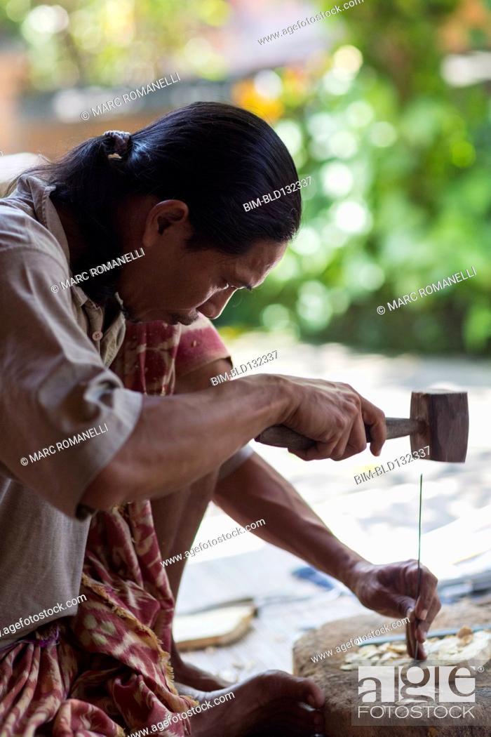 Stock Photo: Wood worker chiseling piece in studio.