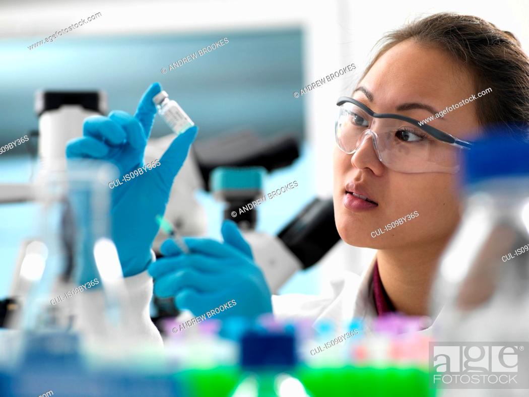 Stock Photo: Scientist preparing new vaccine drug in laboratory for a patient.