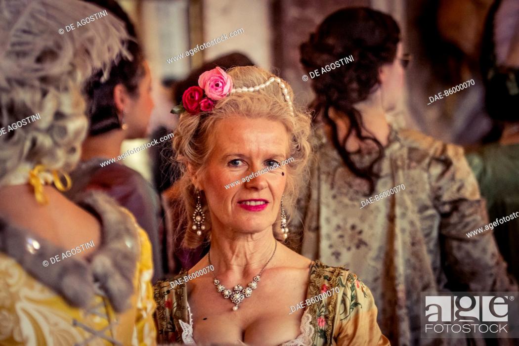Stock Photo: A lady in the Hall of Mirrors, courtship party (Fete galante) with participants wearing clothes from the Louis XIV period, Palace of Versailles, France.