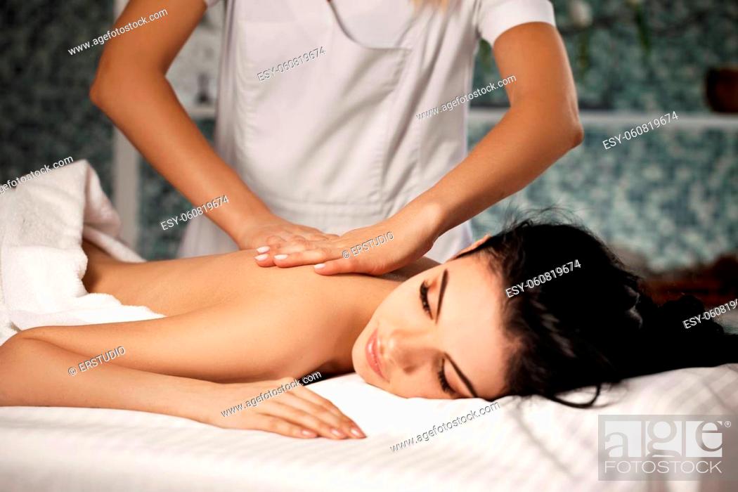 Stock Photo: Relaxed beautiful young woman receiving massage in spa salon. Beauty treatment.