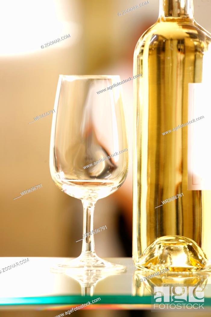 Stock Photo: White wine glass with white wine bottle and pumpkin.