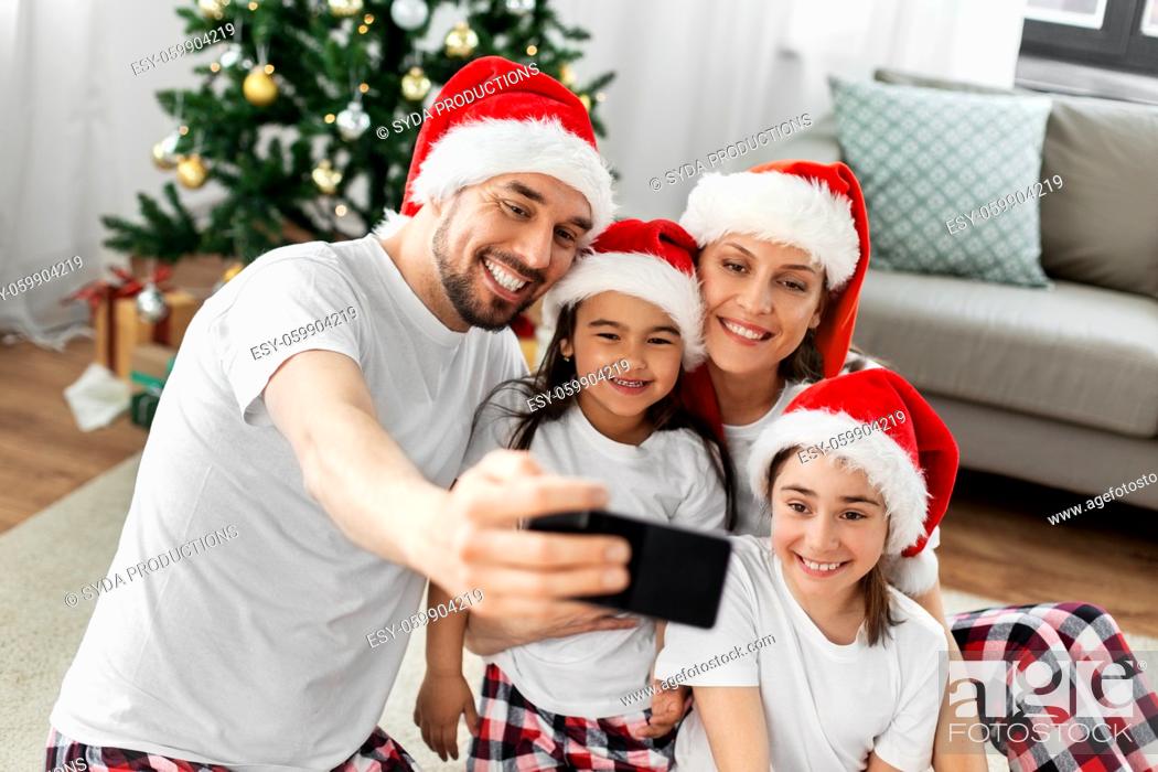 Stock Photo: happy family taking selfie on christmas at home.
