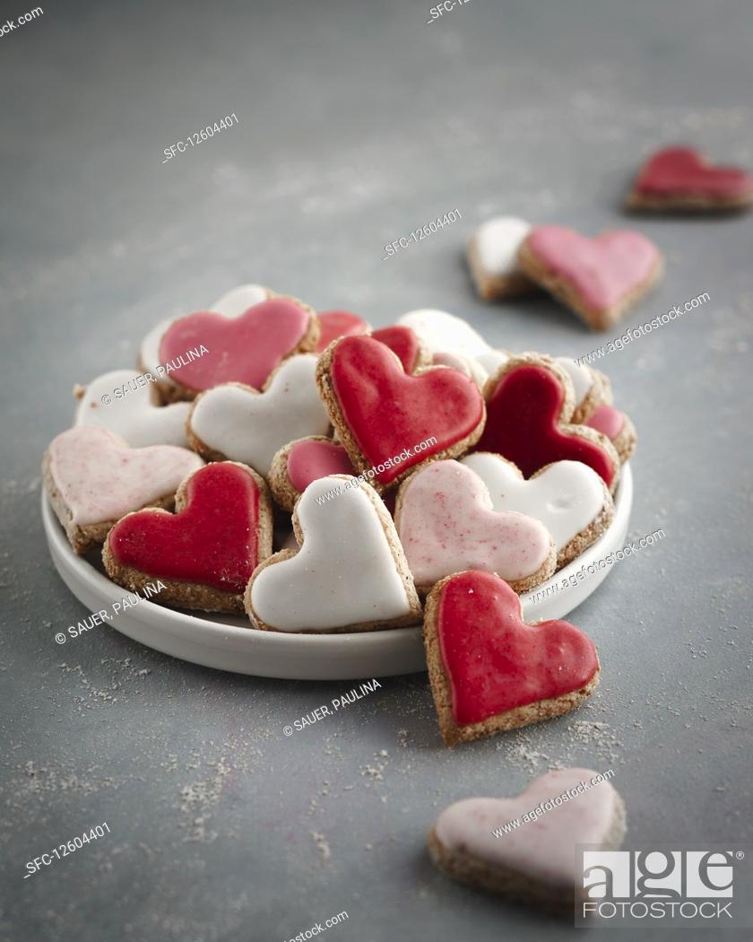 Stock Photo: Pink, red and white heart-shaped biscuits on a plate.