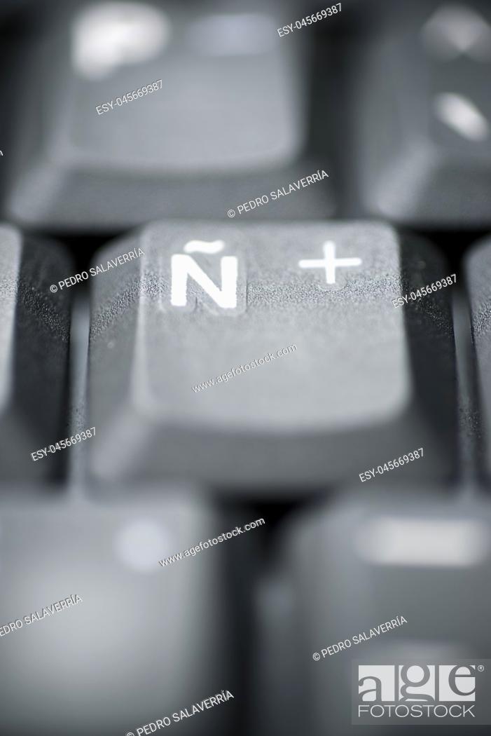 Stock Photo: Spanish letter on a gray laptop keyboard.