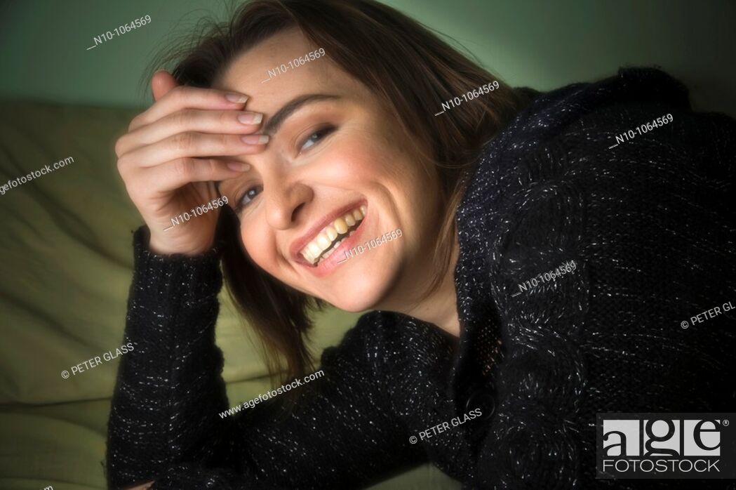 Stock Photo: Young woman lying on her bed.