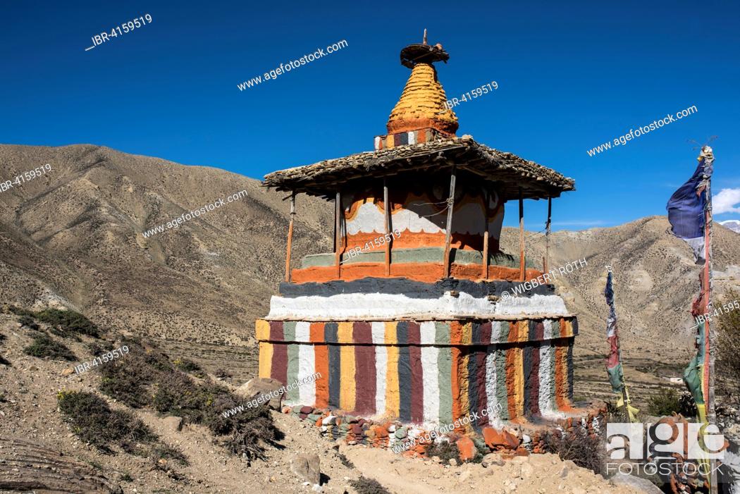 Stock Photo: Colourfully painted Buddhist stupa in front of mountain landscape, Samar, Mustang, Nepal.