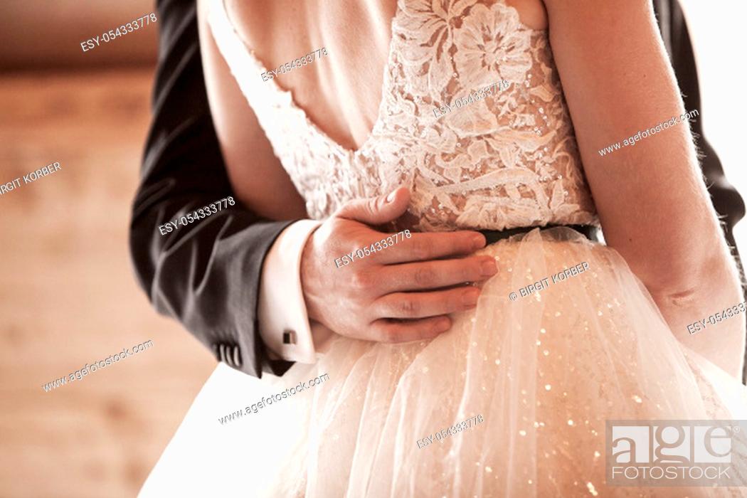 Stock Photo: Bride and groom at marriage hold each other, closeup of hands.