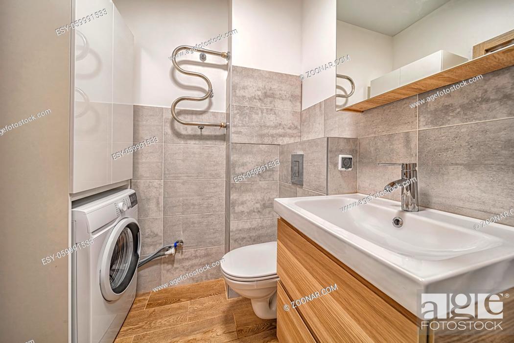 Imagen: Tiny modern bathroom with toilet, sink, mirror, washing machine and cabinet contemporary interior design.