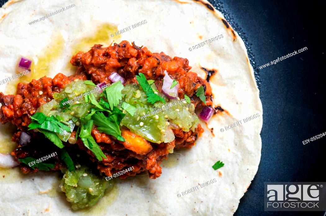 Stock Photo: Vegetarian, vegan tacos al pastor with green salsa. Soya protein cooked with al pastor marinade and served on corn tortillas.