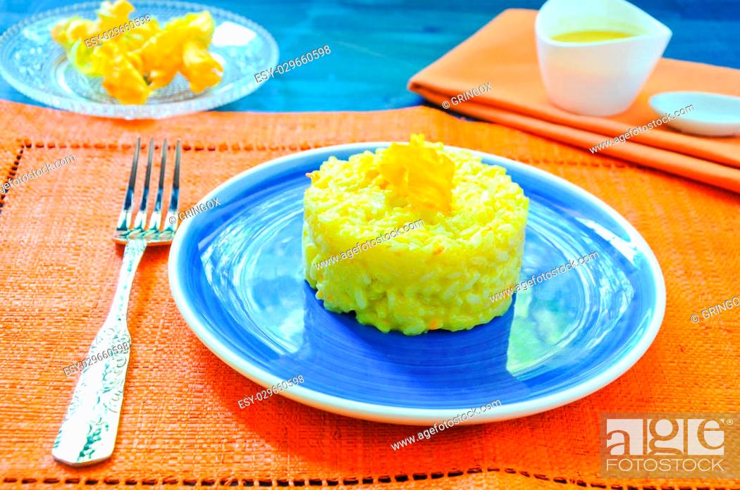 Stock Photo: Risotto with pumpkin flowers with saffron cream.