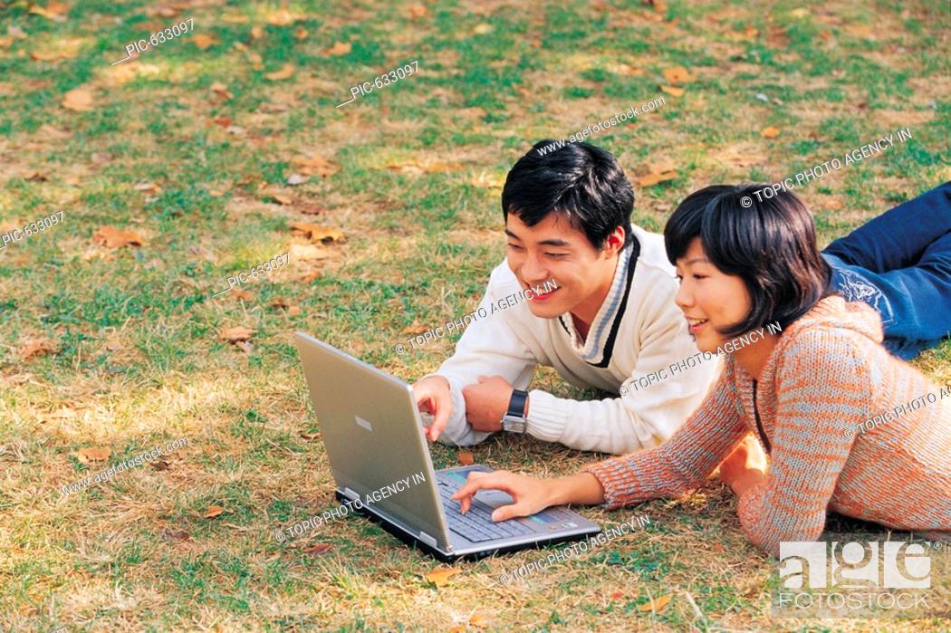 Stock Photo: Young Korean People Enjoying Picnic at Park.