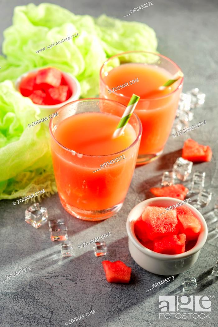 Stock Photo: Watermelon drink with ice in glasses on gray concrete background.