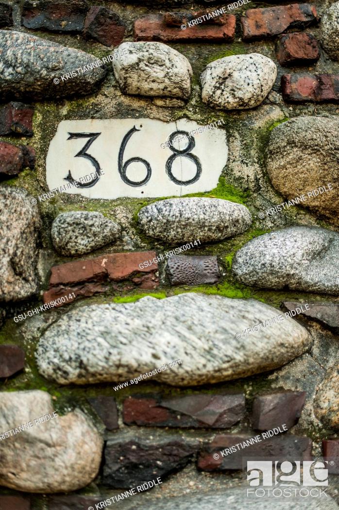 Stock Photo: House Number in Stone Wall.