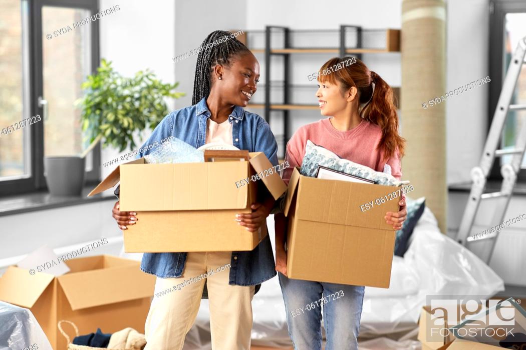 Stock Photo: women with boxes moving to new home.