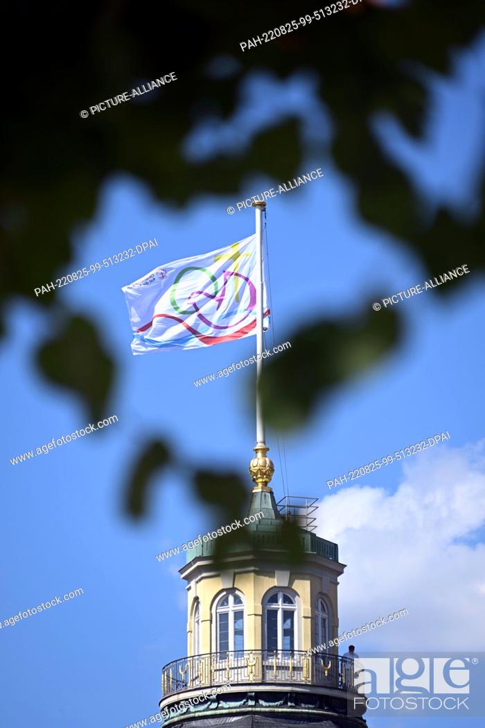 Stock Photo: 25 August 2022, Baden-Wuerttemberg, Karlsruhe: A flag flies at the castle for the 11th Assembly of the World Council of Churches.