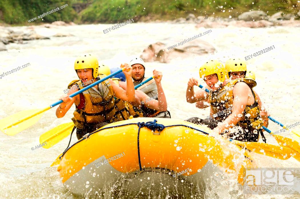 Stock Photo: Group Of Mixed Tourist Men And Women With Guided By Professional Pilot On Whitewater River Rafting In Ecuador.