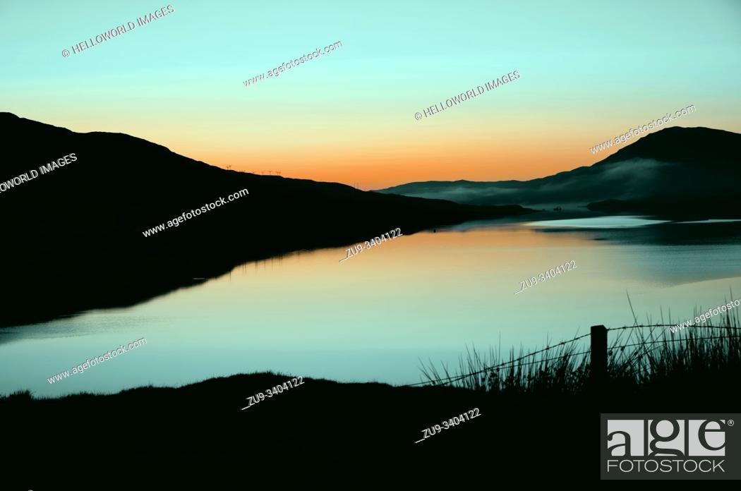 Stock Photo: Stunning summer dawn over misty loch, Isle of Lewis, Outer Hebrides, Scotland.