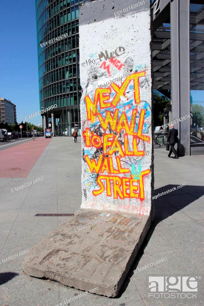 Stock Photo: BERLIN - MAY 15: Part of the Berlin Wall with a 99 Percent' movement graffiti on May 15, 2013 in Berlin, Germany. Berlin Wall was a barrier constructed by the.
