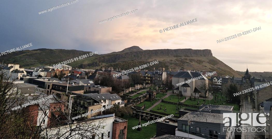 Stock Photo: 24 March 2023, Great Britain, Edinburgh: A rock rises up behind the old city of Edinburgh. The supporters of Scottish independence want to get rid of the.
