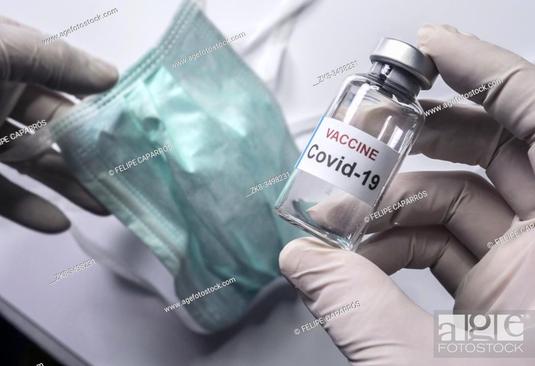 Stock Photo: Scientist holds a coronavirus vaccine, conceptual image.
