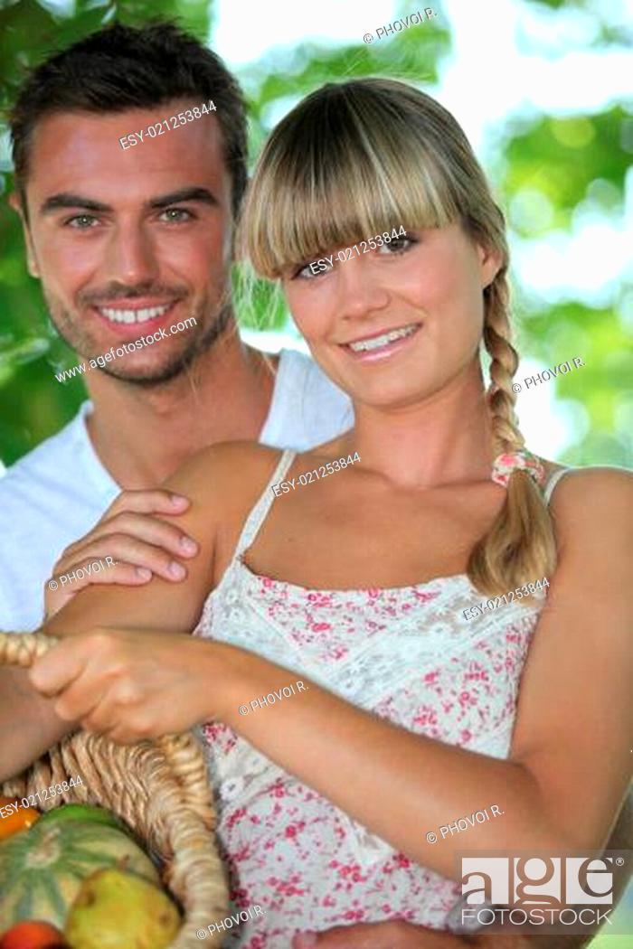 Stock Photo: Couple in park with vegetable basket.