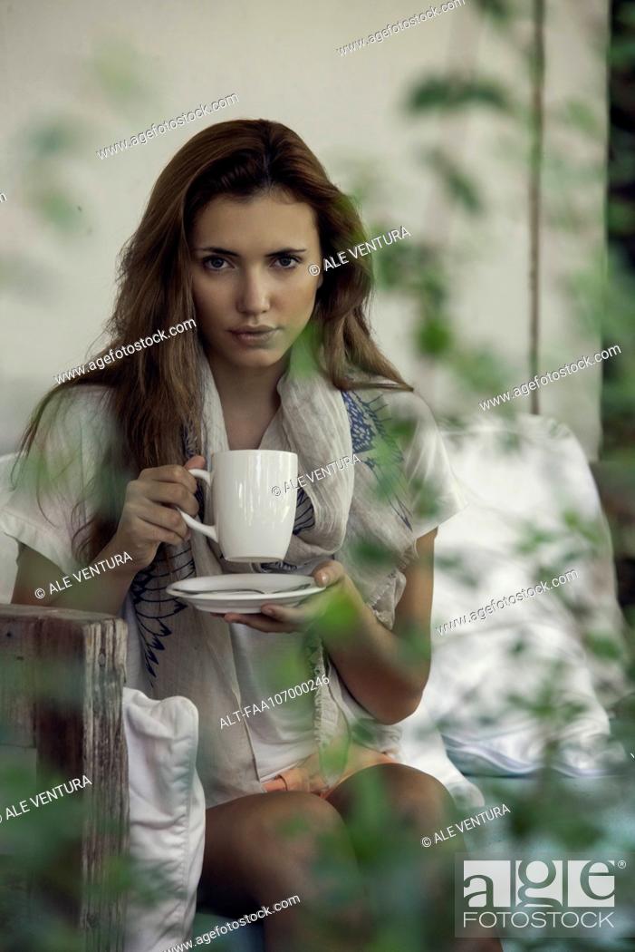 Stock Photo: Woman enjoying hot drink outdoors.
