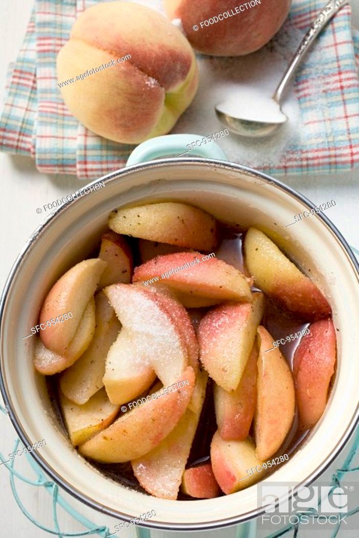 Stock Photo: Sugared peaches with water in pan.