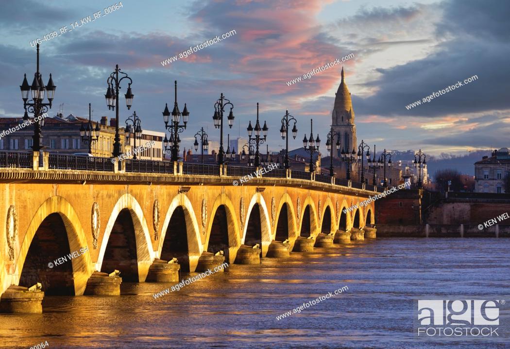 Stock Photo: Bordeaux, Gironde Department, Aquitaine, France. Pont de Pierre or the Stone Bridge, built between 1819 and 1822. The spire belongs to the church of Église.