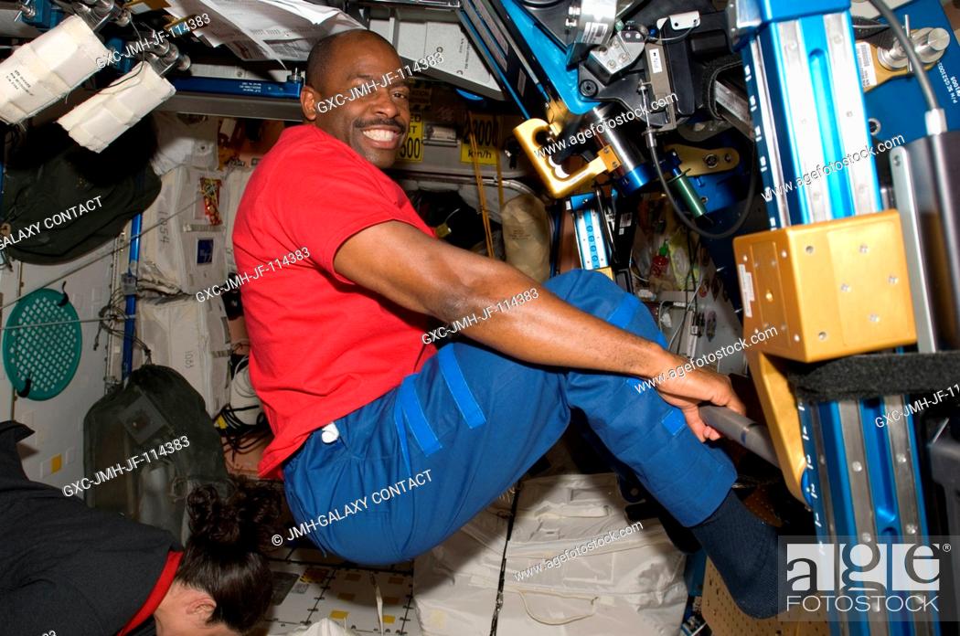 Stock Photo: Astronaut Leland Melvin, STS-129 mission specialist, exercises using the advanced Resistive Exercise Device (aRED) in the Unity node of the International Space.