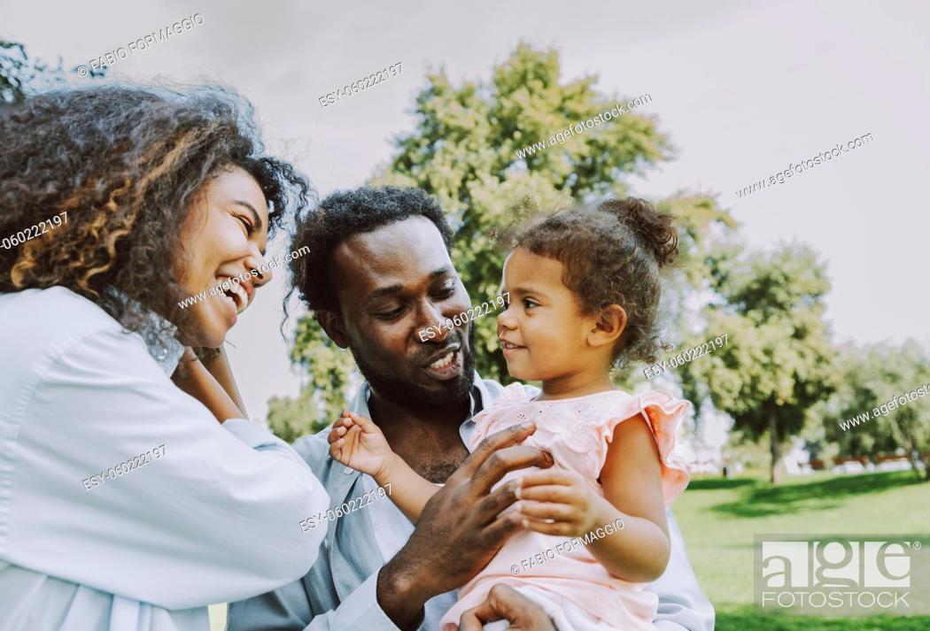Stock Photo: Beautiful happy african american family bonding at the park - Black family having fun outdoors.