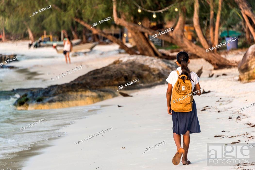 Stock Photo: Local girls walking to school on idyllic sandy beach at Koh Tui Beach, Koh Touch village, Koh Rong island, Krong Preah Sihanouk, Sihanoukville, Cambodia.